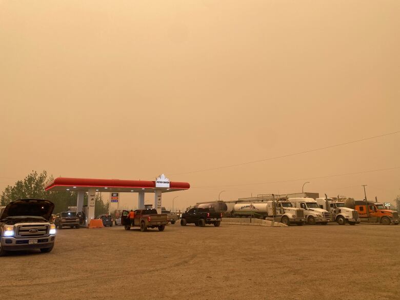 A gas station against a smoky sky.