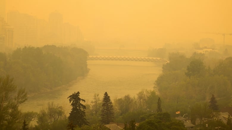 Smoke from northern Alberta forest fires blankets the Bow River area near downtown Calgary.