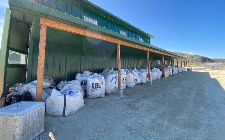 Numerous bags of recycled material sitting outside of the new solid waste diversion facility.