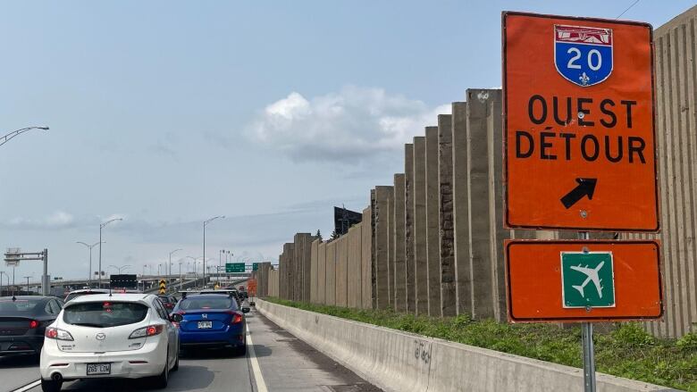 highway 20 full of traffic and detour sign