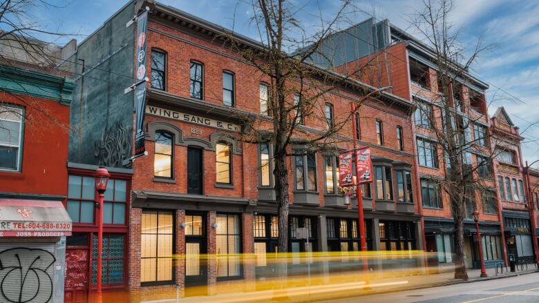 A brick building is pictured in Vancouver's Chinaton with the sign 