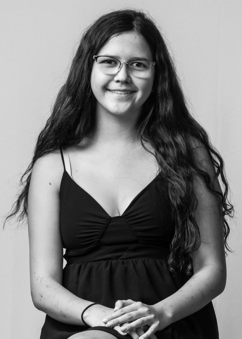 head shot of woman with long dark hair and glasses