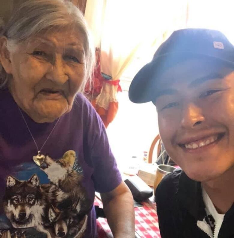 A photo of a smiling elderly woman and a grinning young person.