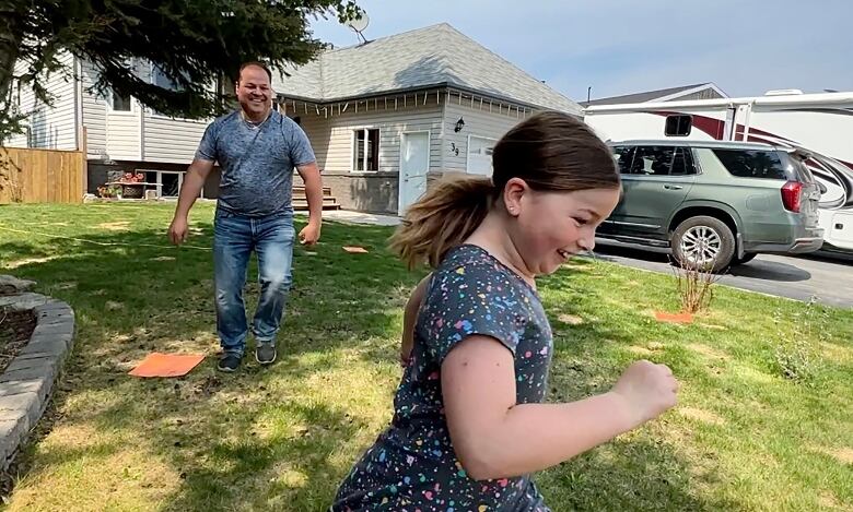 a father and daughter playing