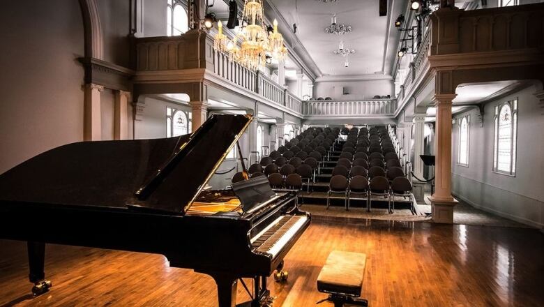 A piano sits in a chapel.