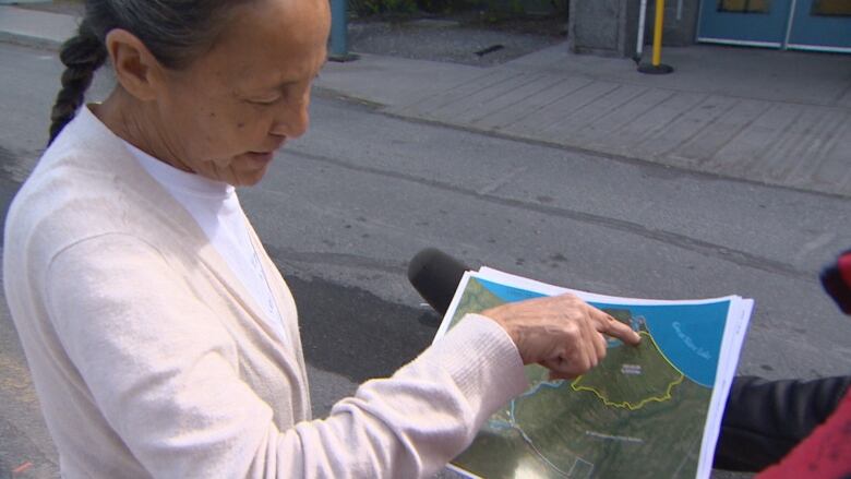 Woman points to paper map