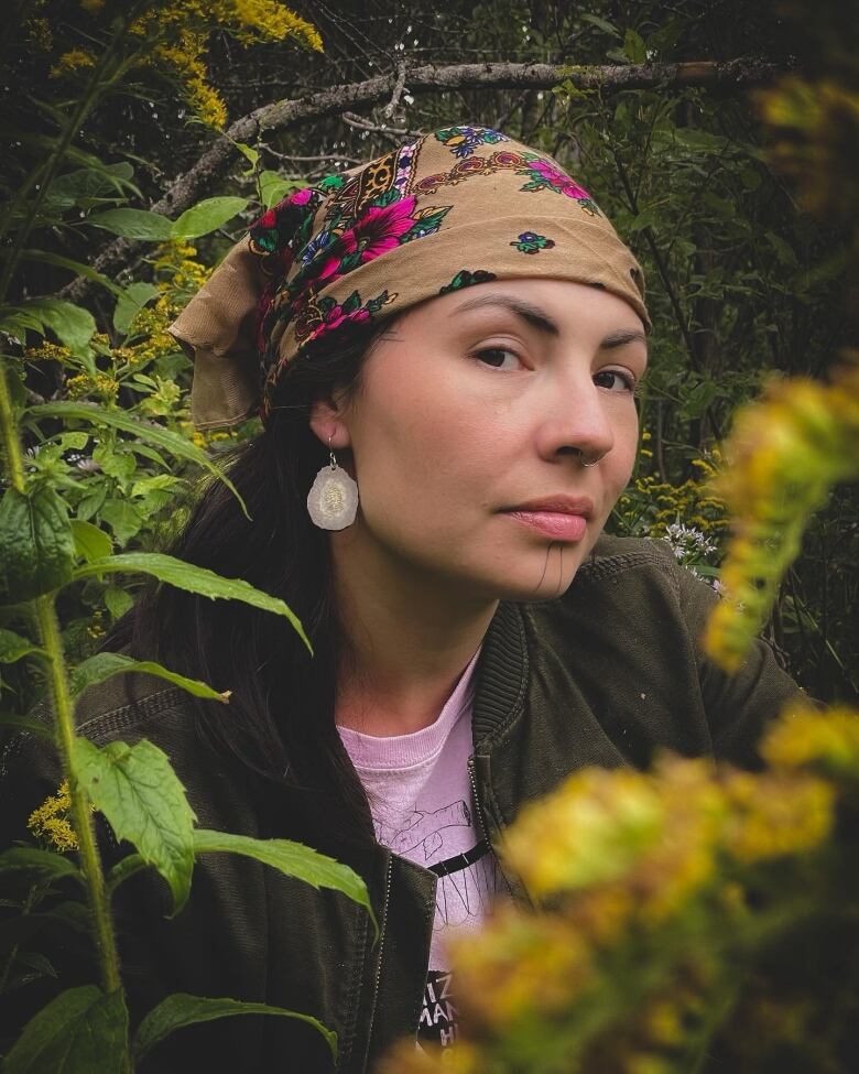 A young woman in a wooded area.