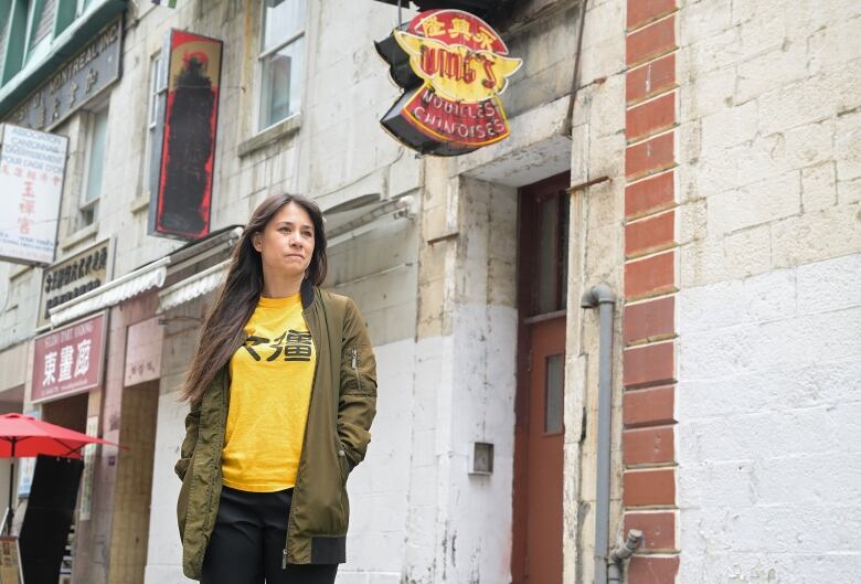 woman standing in front of noodle shop