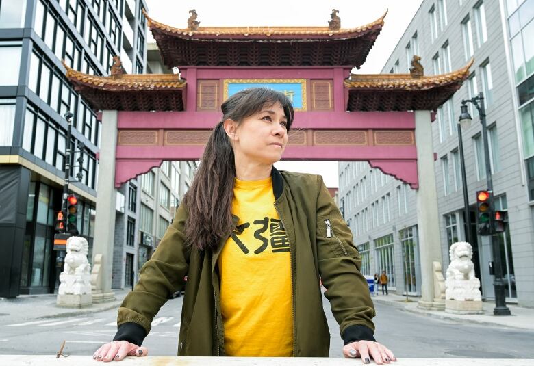 woman in front of the entrance to Montreal's Chinatown.