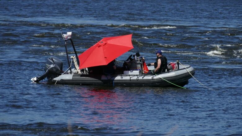 RCMP are shown on a boat in the middle of a body of water.