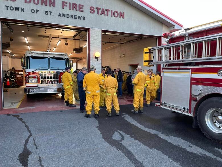 Firefighters huddked outside station