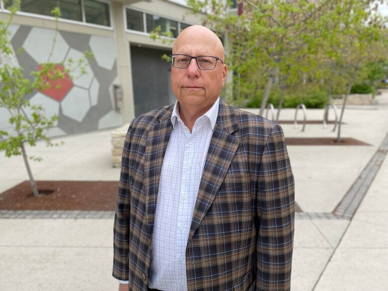 A man standing on a pedestrian-only street in Winnipeg.