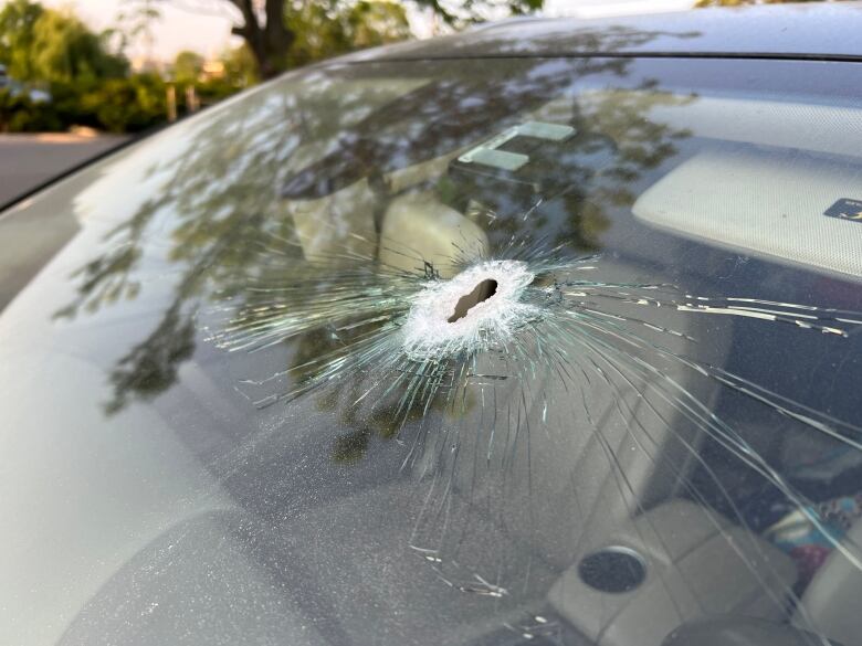 windshield with bullet hole