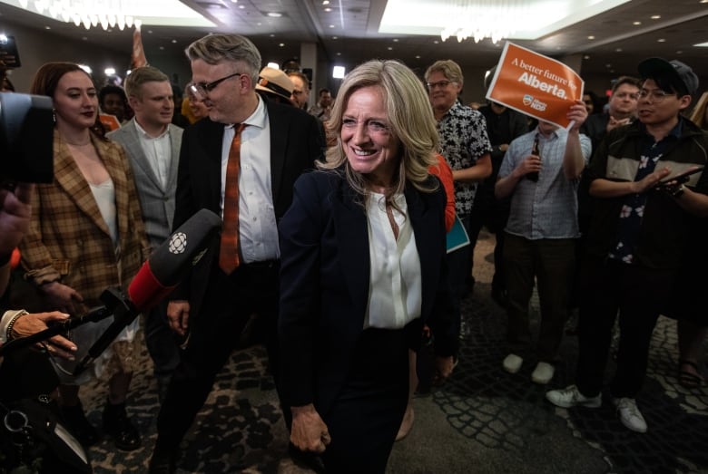 Leader of the NDP Rachel Notley makes her way through a crowd of supporters.