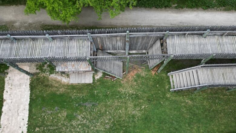 A damaged wooden structure is shown. It appears to have collapsed internally.