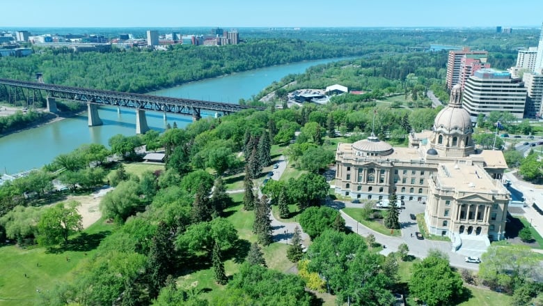 Aerial view of Alberta Legislature Building and Downtown Edmonton skyline on a sunny day.