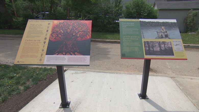 Two plaques titled 'Tree of Life' and 'From Ancient Forest to Elm Park' stand on a walkway. 