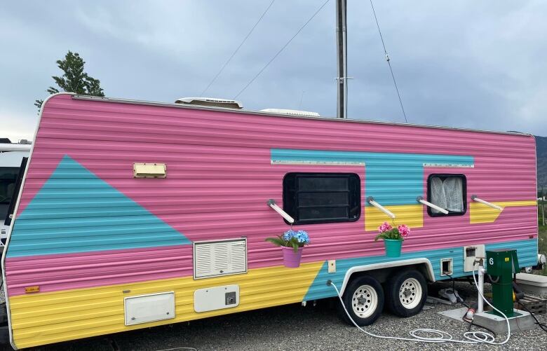 A brightly coloured trailer in pink, blue and yellow.