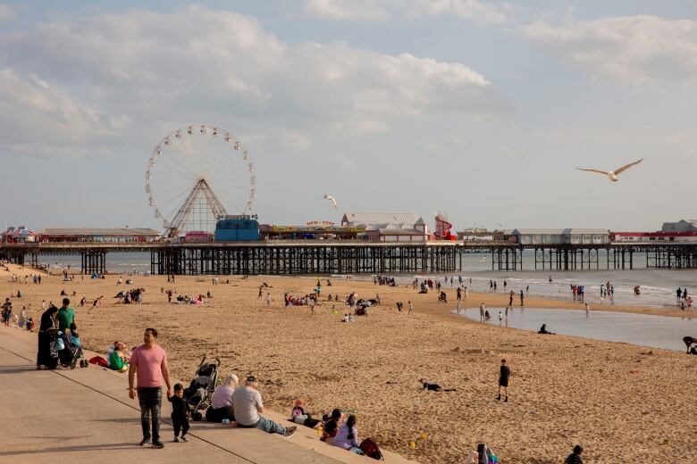 Tourists at the Central Pier in Blackpool, England.