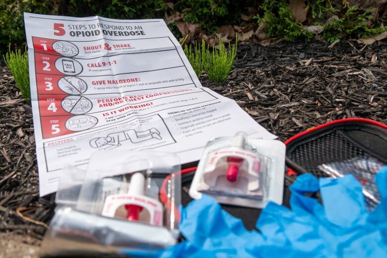 A naloxone kit on a curb.