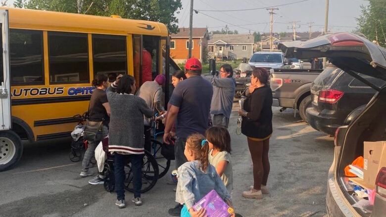 people getting into a yellow bus