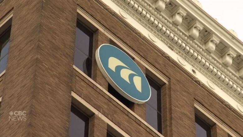 The top corner of a brown brick building with the MPI logo.