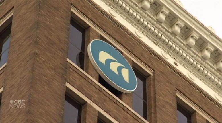 The top corner of a brown brick building with the MPI logo.