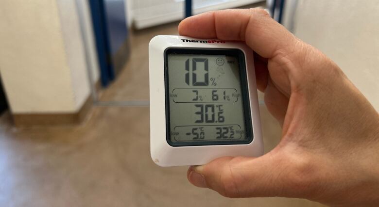 An indoor thermometer shows the inside of a building is 30 degrees C.