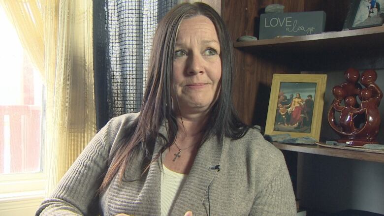 A woman sits in a wheelchair by a window at her home in Newfoundland and Labrador.