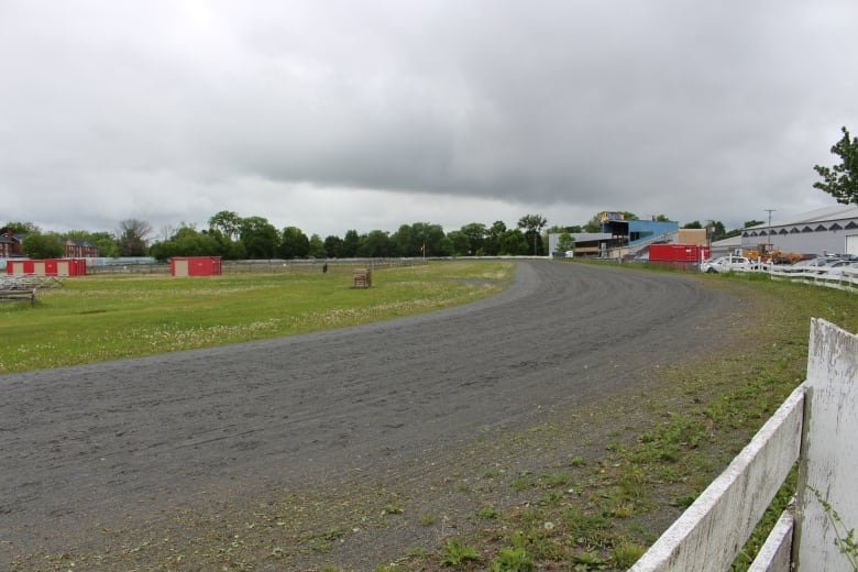 An empty race track on a cloudy day.