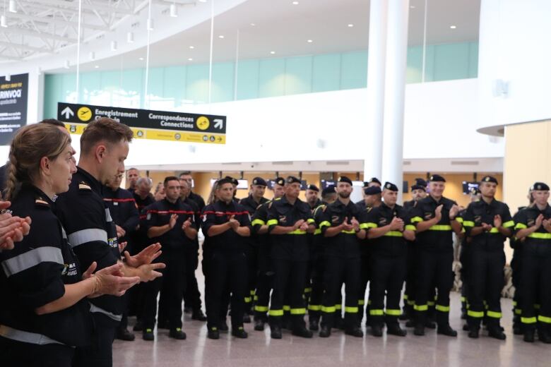 Firefighters stand in a room.