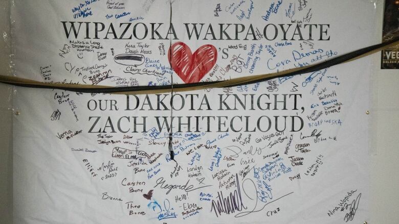 A poster has signature surounding the name of Las Vegas Golden Knight defenceman Zach Whitecloud.