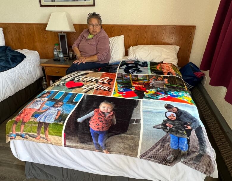 a woman looking at a blanket 