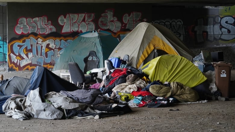 Tents with sleeping bags around them, under the Ville-Marie expressway. 