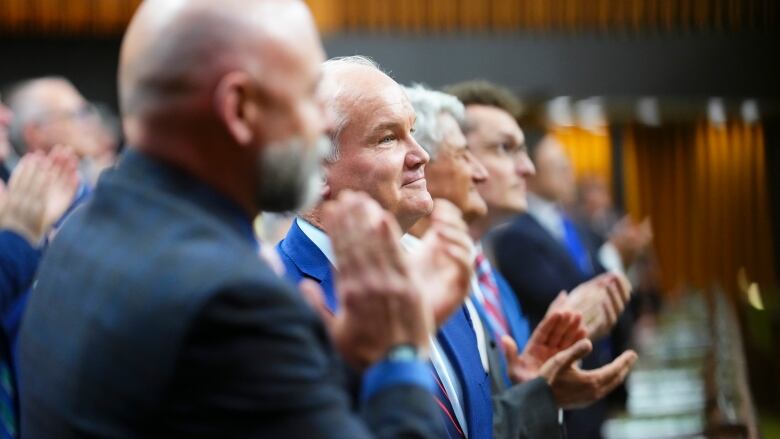 MPs stand to applaud Erin O'Toole after his final speech in the House of Commons.