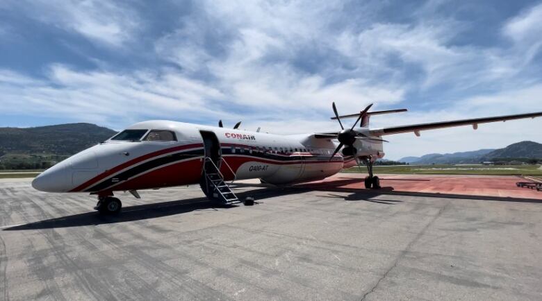 An aircraft sits on a tarmac.