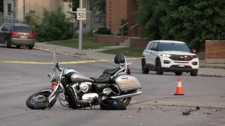 A crashed motorcycle, with broken pieces on the ground.