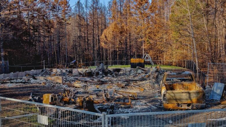 A destroyed home in the community of Yankeetown, outside Halifax, is shown Monday, June 12, 2023, after the area reopened following a wildfire.