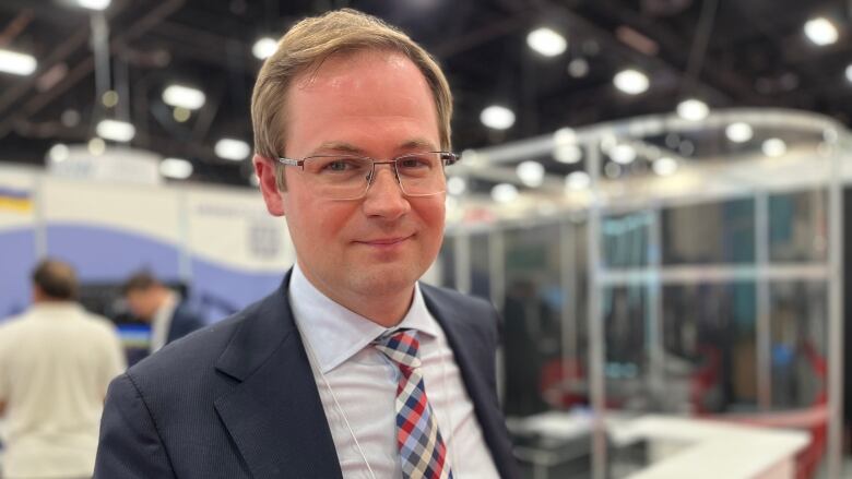 Denys Kudin, executive vice-president for corporate strategy and development with Ukrnafta, poses at the company's exhibitor booth at the Global Energy Show in Calgary. 