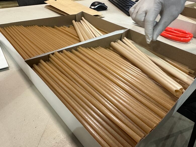 Two boxes of plant-based straws sit on a table.