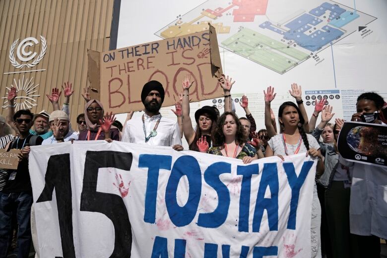 Demonstrators participate in a protest advocating for the 1.5 degree warming goal at the 2022 COP27 climate summit in Egypt. 