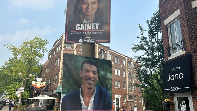 Campaign signs hang on a light standard.