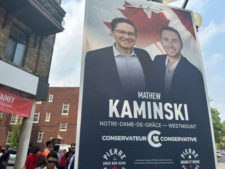 A campaign sign hangs on a pole.