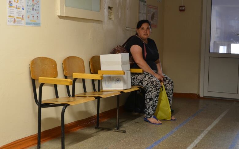 Alina Stasko, who fled her home in suburban Kherson, waits for a room at an internally displaced shelter in Mykolaiv. 