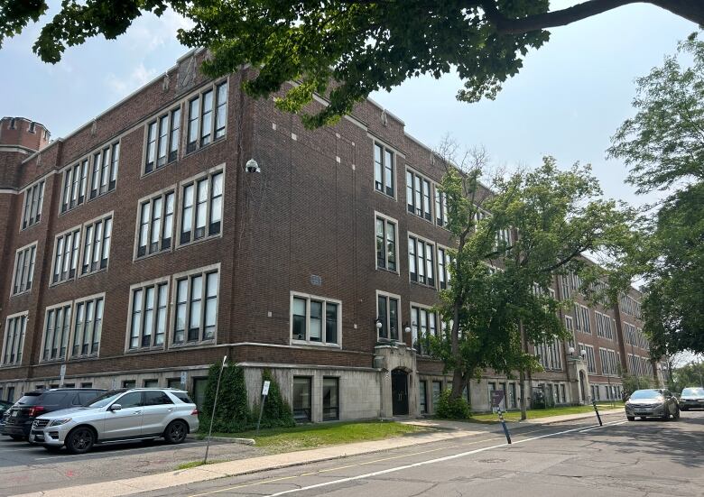 The brick exterior of a school in late spring.