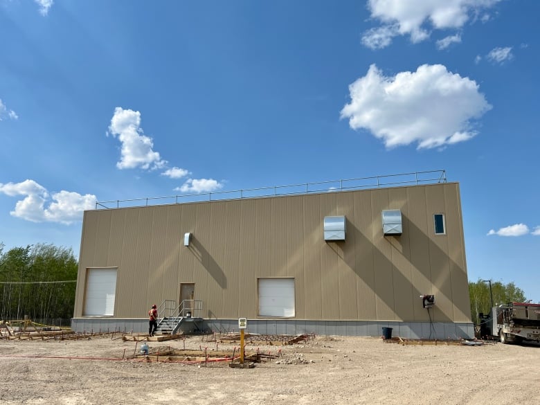 A large brown warehouse-like building, seen from the outside.