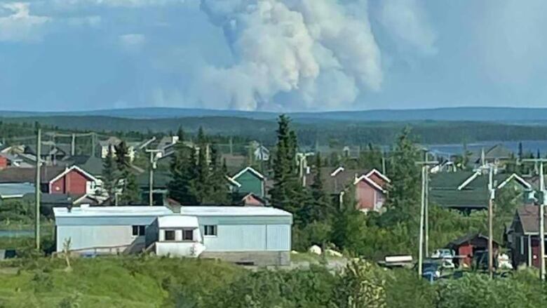 A picture of Mistissini, Que on June 19 with a fire burning in the distance. 