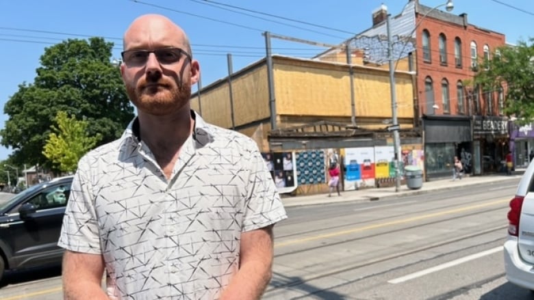 Adam Wynne, a local historian with a special interest in the history of Queen West, stands in front of 520 Queen St. W. as it looks since being rebuilt after the demolition of the original 1850s structure.