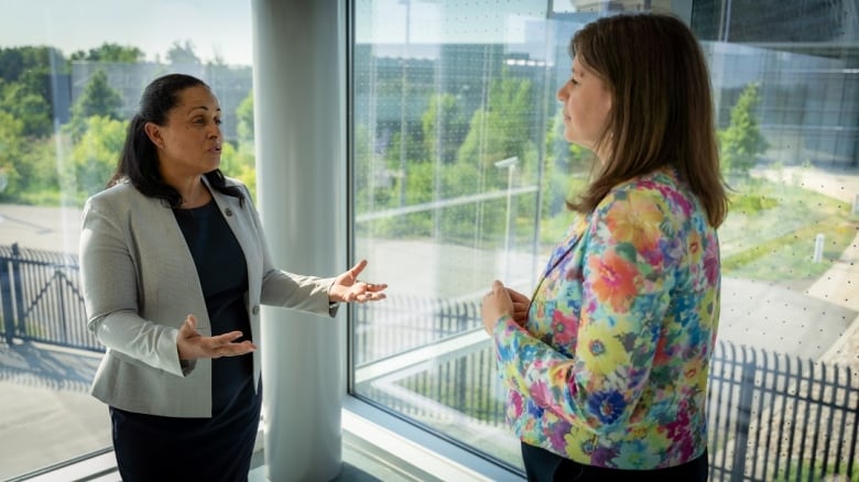 Two women have a conversation.