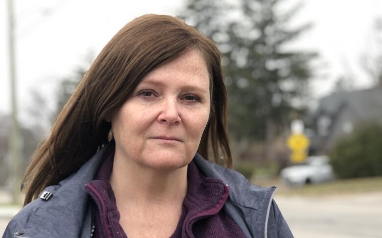 woman looks at camera in unnamed park